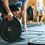 Man Holding Black Barbell